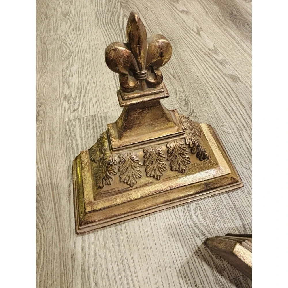 Vintage gold-toned decorative wall shelves with floral motifs.